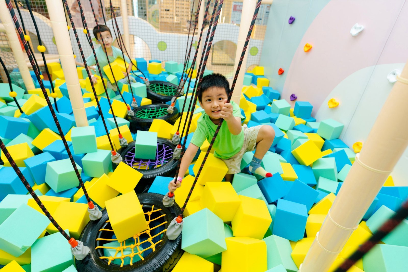 Child enjoying DreamDora foam adventure area