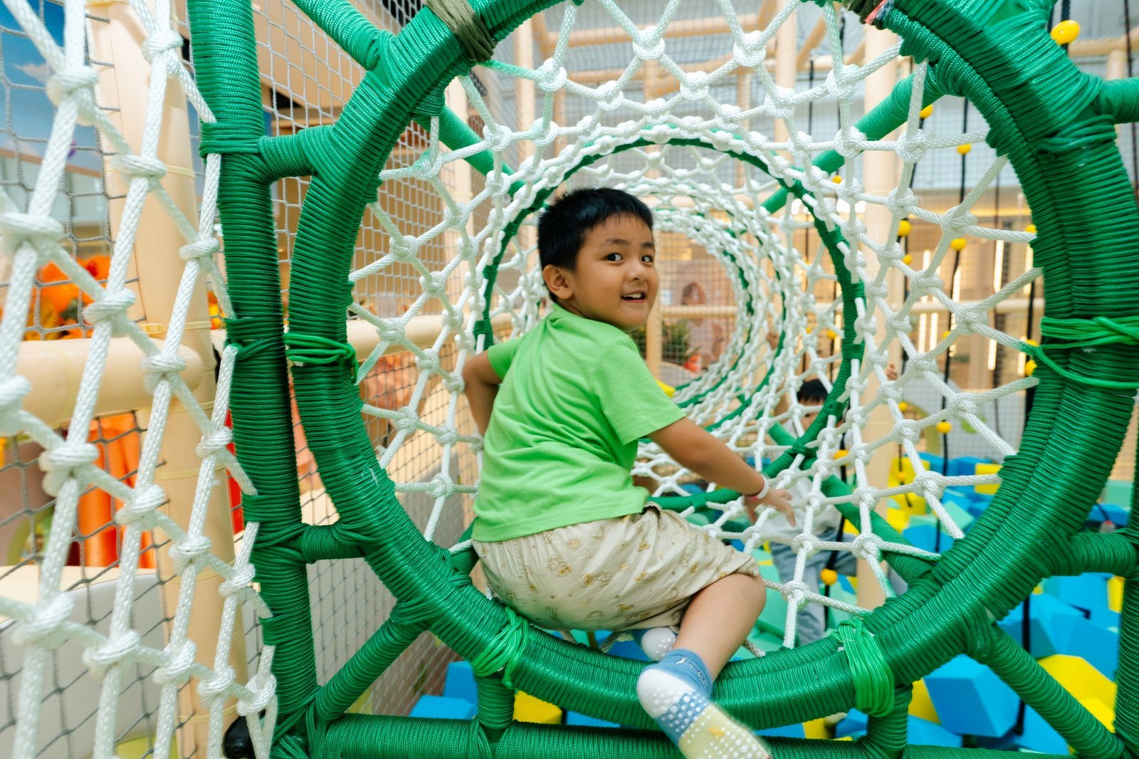 Child exploring the DreamDora adventure tunnel